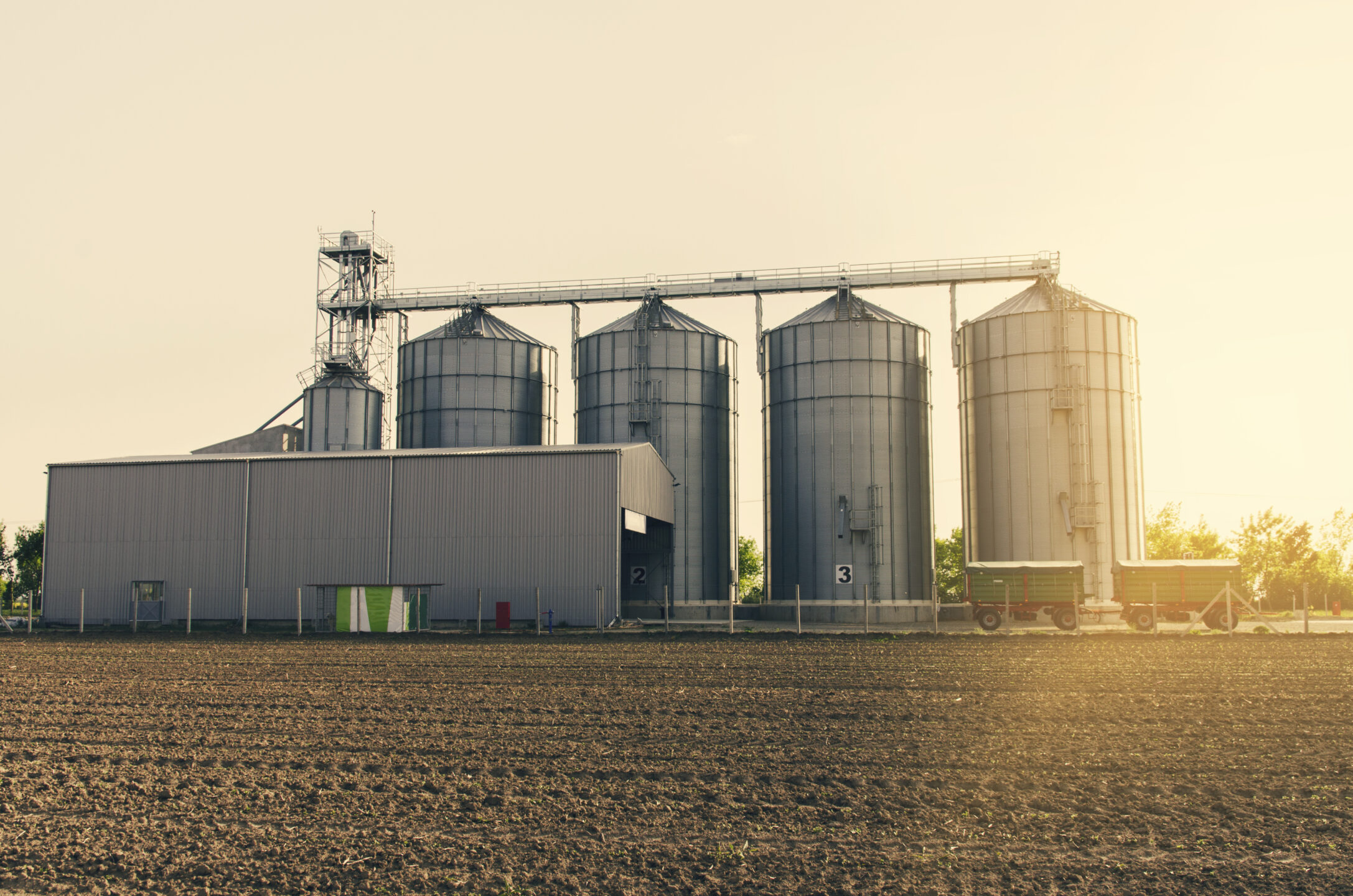 Agricultural Silos On Sunset