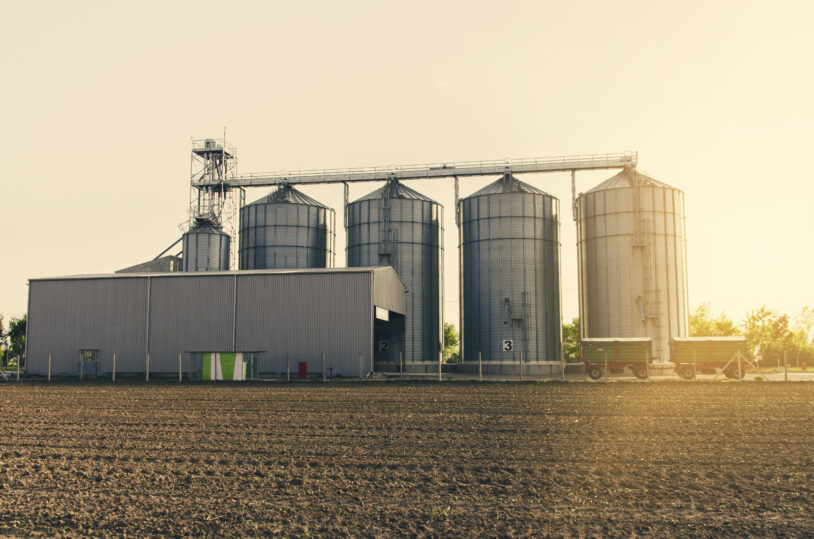 Agricultural Silos On Sunset